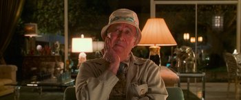 Movie still from “Ocean's Eleven” (2001), directed by Steven Soderbergh – An older man wearing a hat and holding his hand to his face; Close Up shot, Over the shoulder angle