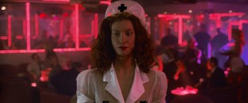 Movie still from “Ocean's Eleven” (2001), directed by Steven Soderbergh – A woman in a nurse's outfit with a cross on her head; Close Up shot, Low angle
