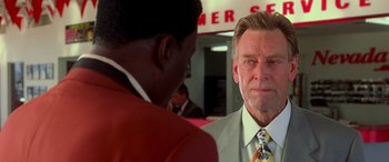 Movie still from “Ocean's Eleven” (2001), directed by Steven Soderbergh – A man in a suit and tie standing next to another man in a suit and tie; Close Up shot, Over the shoulder angle