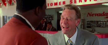 Movie still from “Ocean's Eleven” (2001), directed by Steven Soderbergh – A man in a suit and tie talking to a man in a suit and tie; Close Up shot, Low angle