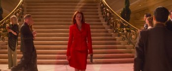 Movie still from “Ocean's Eleven” (2001), directed by Steven Soderbergh – A woman in a red suit walking down the stairs; Medium shot, Low angle