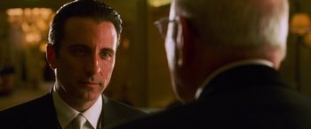 Movie still from “Ocean's Eleven” (2001), directed by Steven Soderbergh – A man in a suit and tie talking to another man in a suit and tie; Close Up shot, Over the shoulder angle