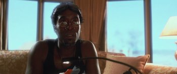 Movie still from “Ocean's Eleven” (2001), directed by Steven Soderbergh – A man sitting on a couch looking up at the sky; Close Up shot, Low angle