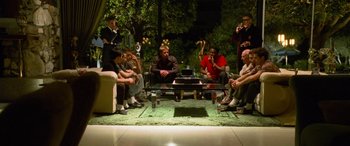 Movie still from “Ocean's Eleven” (2001), directed by Steven Soderbergh – A group of people sitting around a coffee table; Wide shot, High angle