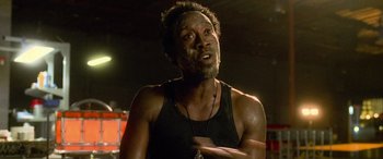 Movie still from “Ocean's Eleven” (2001), directed by Steven Soderbergh – A man in a black tank top is pointing to the ground; Close Up shot, Low angle