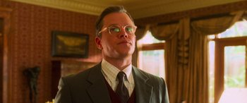 Movie still from “Ocean's Eleven” (2001), directed by Steven Soderbergh – A man in a suit and glasses looking up; Close Up shot, Low angle