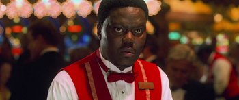 Movie still from “Ocean's Eleven” (2001), directed by Steven Soderbergh – A person wearing a red vest; Close Up shot, High angle