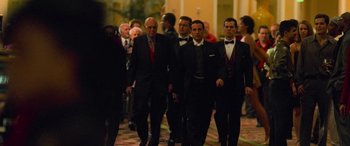 Movie still from “Ocean's Eleven” (2001), directed by Steven Soderbergh – A group of men in tuxedos walking down a hallway; Wide shot, Over the shoulder angle