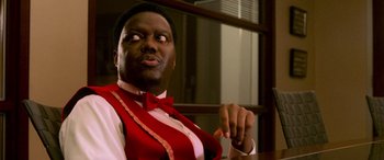 Movie still from “Ocean's Eleven” (2001), directed by Steven Soderbergh – A man sitting at a table wearing a bow tie; Close Up shot, Over the shoulder angle