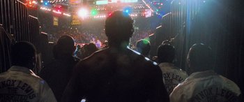 Movie still from “Ocean's Eleven” (2001), directed by Steven Soderbergh – A crowd of people standing in front of a stage; Wide shot, Over the shoulder angle