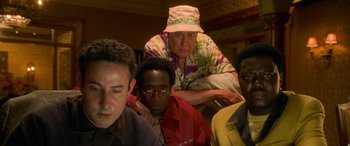 Movie still from “Ocean's Eleven” (2001), directed by Steven Soderbergh – A group of men sitting next to each other in a room; Medium shot, Low angle