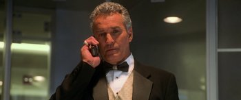 Movie still from “Ocean's Eleven” (2001), directed by Steven Soderbergh – An older man in a tuxedo talking on a cell phone; Close Up shot, Low angle