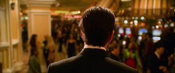 Movie still from “Ocean's Eleven” (2001), directed by Steven Soderbergh – A person wearing a suit and tie; Close Up shot, Over the shoulder angle
