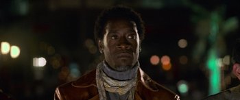 Movie still from “Ocean's Eleven” (2001), directed by Steven Soderbergh – A person wearing a brown jacket; Close Up shot, Low angle