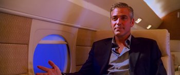 Movie still from “Ocean's Thirteen” (2007), directed by Steven Soderbergh – A person sitting on a plane; Medium shot, Low angle