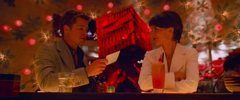 Movie still from “Ocean's Thirteen” (2007), directed by Steven Soderbergh – A man and a woman sitting at a table; Medium shot, Low angle