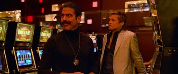 Movie still from “Ocean's Thirteen” (2007), directed by Steven Soderbergh – A man in a black shirt and a man in a white jacket; Medium shot, Over the shoulder angle