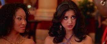 Movie still from “Ocean's Thirteen” (2007), directed by Steven Soderbergh – A woman with long dark brown hair wearing a dress; Close Up shot, Over the shoulder angle