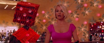 Movie still from “Ocean's Thirteen” (2007), directed by Steven Soderbergh – A woman in a pink dress standing in front of a wall; Medium shot, Low angle