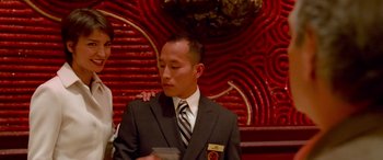 Movie still from “Ocean's Thirteen” (2007), directed by Steven Soderbergh – A man in a suit and tie holding a drink; Medium shot, Low angle