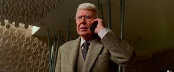 Movie still from “Ocean's Thirteen” (2007), directed by Steven Soderbergh – An older man wearing a suit and tie talking on a cell phone; Close Up shot, Low angle