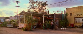 Movie still from “Ocean's Thirteen” (2007), directed by Steven Soderbergh – A group of people standing outside of an outdoor restaurant; Extreme Wide shot, High angle