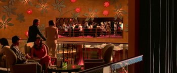 Movie still from “Ocean's Thirteen” (2007), directed by Steven Soderbergh – People are gathered in a large room at a restaurant; Extreme Wide shot, High angle