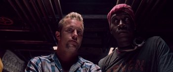 Movie still from “Ocean's Thirteen” (2007), directed by Steven Soderbergh – A man and a man with a bandana on their head; Close Up shot, Low angle