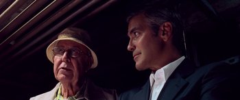 Movie still from “Ocean's Thirteen” (2007), directed by Steven Soderbergh – A man and a man wearing a hat looking at each other; Close Up shot, Low angle