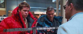 Movie still from “Ocean's Thirteen” (2007), directed by Steven Soderbergh – Two men sitting next to each other on a bench; Medium shot, Over the shoulder angle