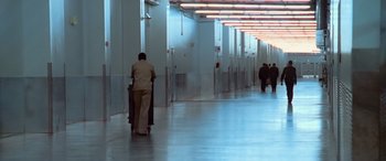 Movie still from “Ocean's Thirteen” (2007), directed by Steven Soderbergh – A man pushing a luggage cart down a hallway; Extreme Wide shot, High angle