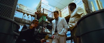 Movie still from “Ocean's Thirteen” (2007), directed by Steven Soderbergh – A group of men standing next to each other in a room; Medium shot, Low angle