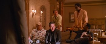 Movie still from “Ocean's Thirteen” (2007), directed by Steven Soderbergh – A group of men sitting around a living room together; Medium shot, Low angle