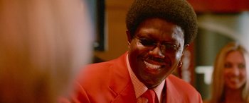 Movie still from “Ocean's Thirteen” (2007), directed by Steven Soderbergh – A person wearing a suit and smiling; Close Up shot, Low angle