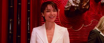 Movie still from “Ocean's Thirteen” (2007), directed by Steven Soderbergh – A woman wearing a white suit smiling for the camera; Close Up shot, Low angle