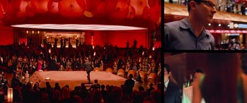 Movie still from “Ocean's Thirteen” (2007), directed by Steven Soderbergh – A group of people sitting in a room with umbrellas; Extreme Wide shot, High angle