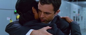 Movie still from “Ocean's Thirteen” (2007), directed by Steven Soderbergh – A man in a suit hugging another man in a suit; Close Up shot, Over the shoulder angle