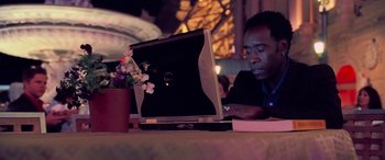 Movie still from “Ocean's Thirteen” (2007), directed by Steven Soderbergh – A man sitting in front of an open laptop computer; Medium shot, Low angle