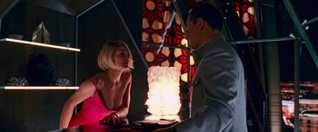 Movie still from “Ocean's Thirteen” (2007), directed by Steven Soderbergh – A man and a woman sitting in front of a lamp; Medium shot, Over the shoulder angle