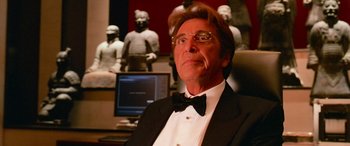 Movie still from “Ocean's Thirteen” (2007), directed by Steven Soderbergh – A man in a tuxedo sitting in front of a computer; Close Up shot, Low angle