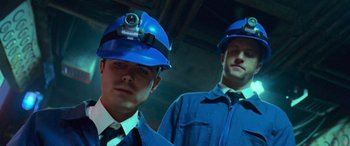 Movie still from “Ocean's Thirteen” (2007), directed by Steven Soderbergh – A couple of men wearing hard hats standing next to each other; Close Up shot, Low angle