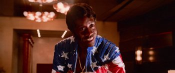 Movie still from “Ocean's Thirteen” (2007), directed by Steven Soderbergh – A person wearing a jacket with stars on it; Close Up shot, Low angle