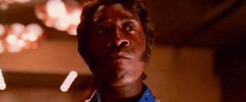 Movie still from “Ocean's Thirteen” (2007), directed by Steven Soderbergh – A person's face in a dark room; Close Up shot, Low angle