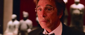 Movie still from “Ocean's Thirteen” (2007), directed by Steven Soderbergh – A person wearing glasses and a bow tie; Close Up shot, Over the shoulder angle