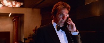 Movie still from “Ocean's Thirteen” (2007), directed by Steven Soderbergh – A man in a tuxedo talking on a phone; Close Up shot, Low angle