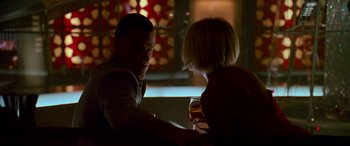 Movie still from “Ocean's Thirteen” (2007), directed by Steven Soderbergh – A man and a woman sitting at a table with a glass of wine; Medium shot, Over the shoulder angle