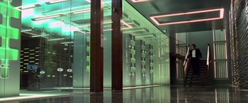 Movie still from “Ocean's Thirteen” (2007), directed by Steven Soderbergh – A glass wall in a building with a green light; Extreme Wide shot, Low angle