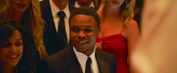 Movie still from “Ocean's Thirteen” (2007), directed by Steven Soderbergh – A man in a suit and tie smiling for the camera; Close Up shot, Low angle