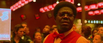 Movie still from “Ocean's Thirteen” (2007), directed by Steven Soderbergh – A man in a red vest and a red bow tie; Close Up shot, Low angle