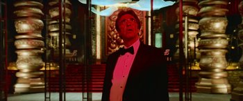 Movie still from “Ocean's Thirteen” (2007), directed by Steven Soderbergh – A man in a suit and bow tie looking up; Medium shot, Low angle